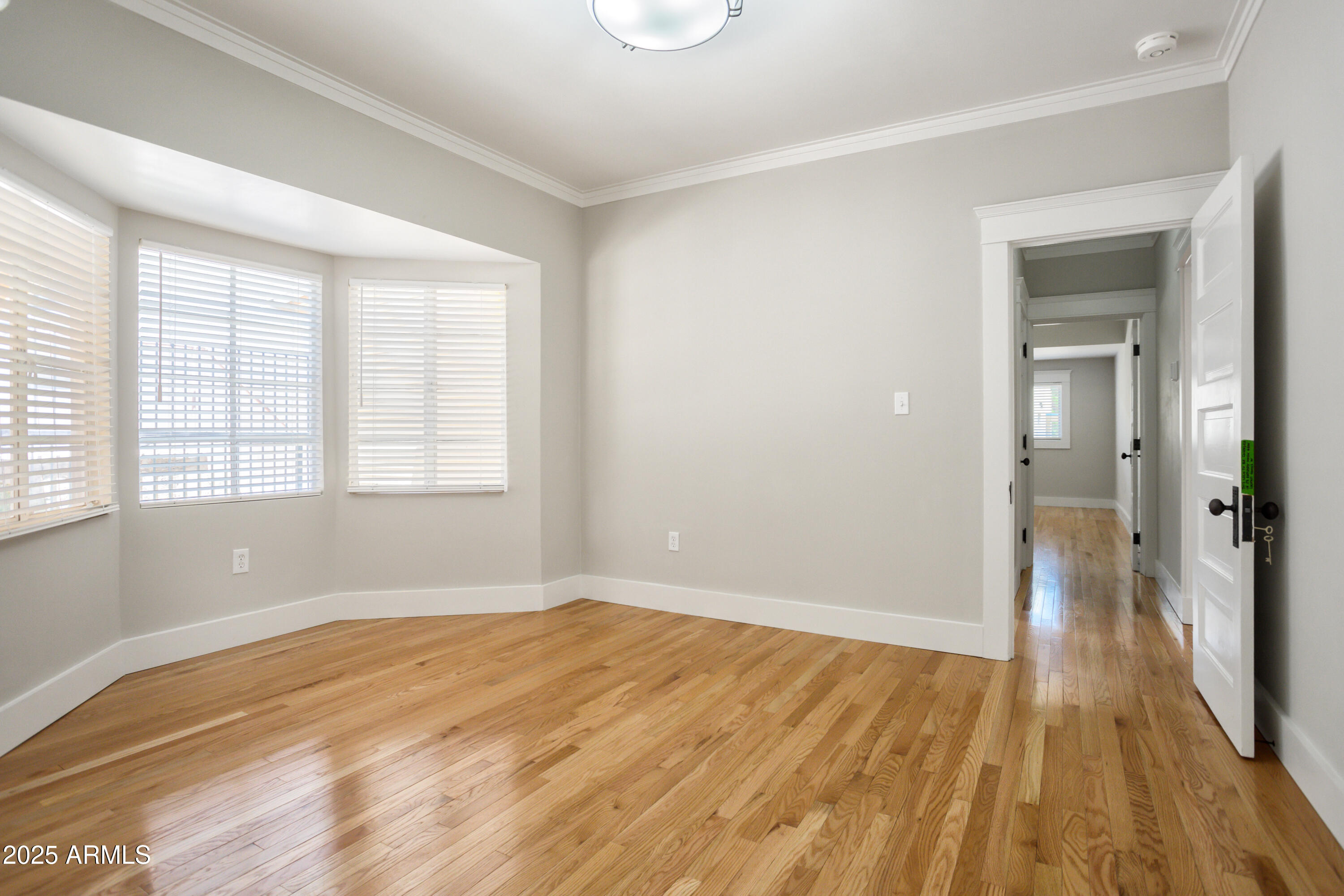 400 Powell Street Bisbee, AZ 85603 - Photo 31 of 57 wooden floor in an empty room with a window