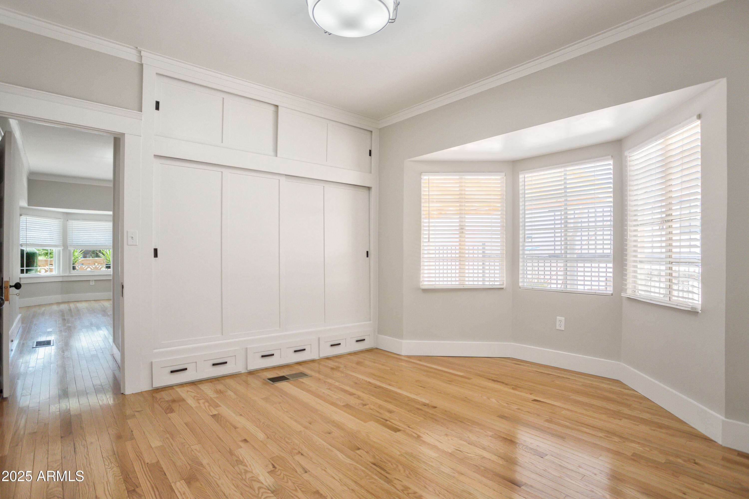 400 Powell Street Bisbee, AZ 85603 - Photo 32 of 57 a view of an empty room with wooden floor and a window