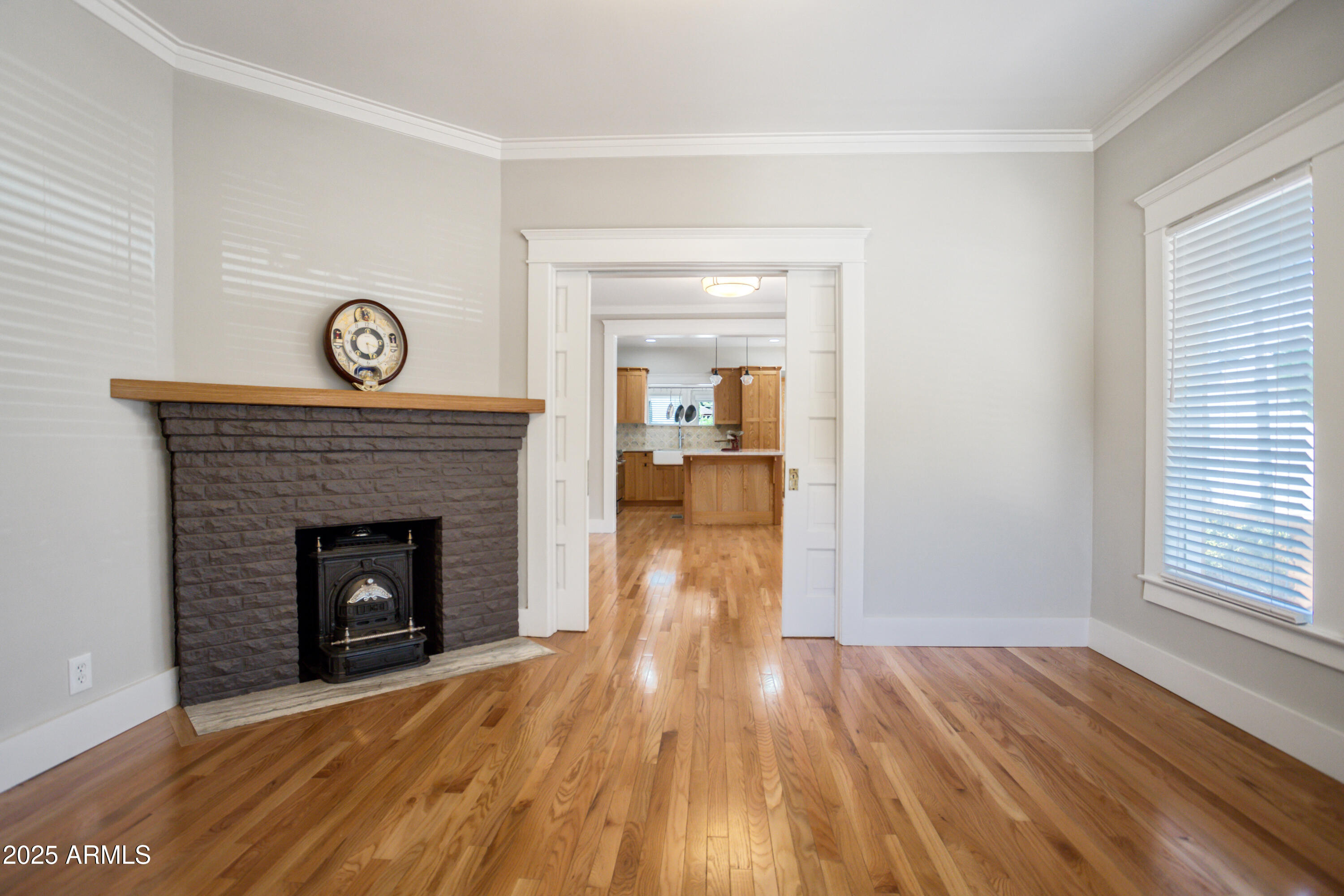400 Powell Street Bisbee, AZ 85603 - Photo 8 of 57 a view of empty room with wooden floor and fireplace