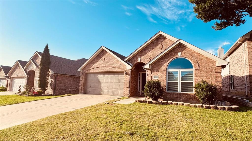 5970 Dustin Trail Frisco, TX 75034 - Photo 2 of 31 Brick exterior with an arched window accent and gabled roofline