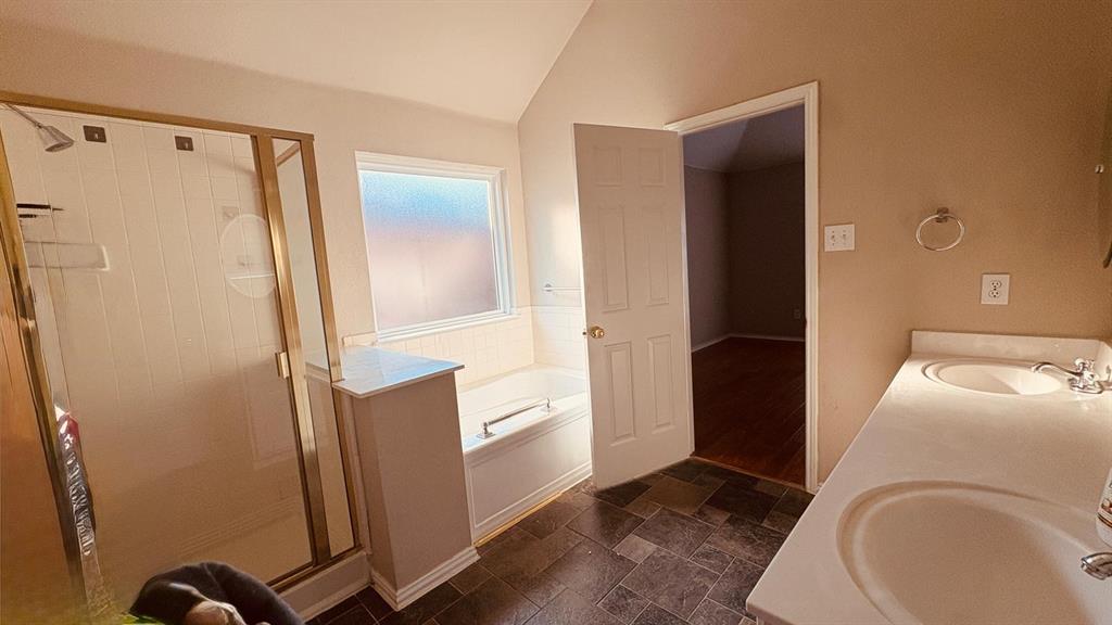 5970 Dustin Trail Frisco, TX 75034 - Photo 21 of 31 Bathroom featuring a dual vanity with integrated sinks, a built-in tub, and a separate shower with a gold-toned frame