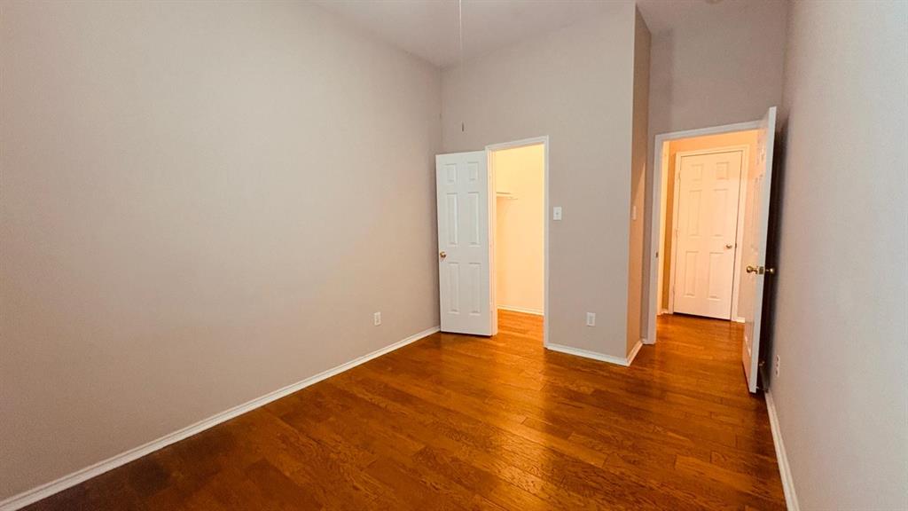 5970 Dustin Trail Frisco, TX 75034 - Photo 23 of 31 Interior room featuring wood-finish flooring, light neutral-toned walls, and white baseboards