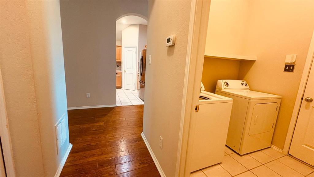 5970 Dustin Trail Frisco, TX 75034 - Photo 27 of 31 Hallway with wood-finish flooring leading to an arched entryway