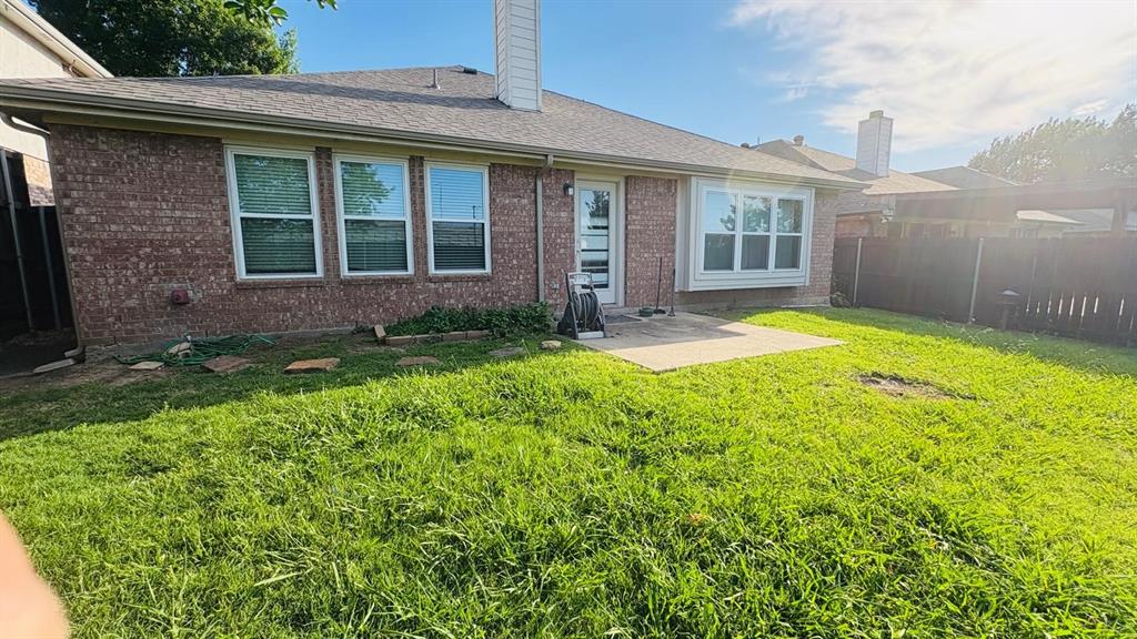 5970 Dustin Trail Frisco, TX 75034 - Photo 31 of 31 Expansive backyard featuring a red brick exterior, a concrete patio, a bay window, and a privacy fence