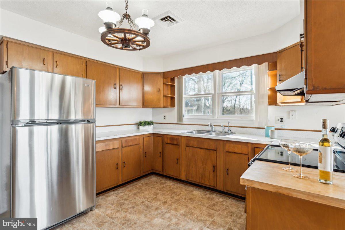 4801 Avery Road Shady Side, MD 20764 - Photo 12 of 25 a kitchen with sink cabinets and window