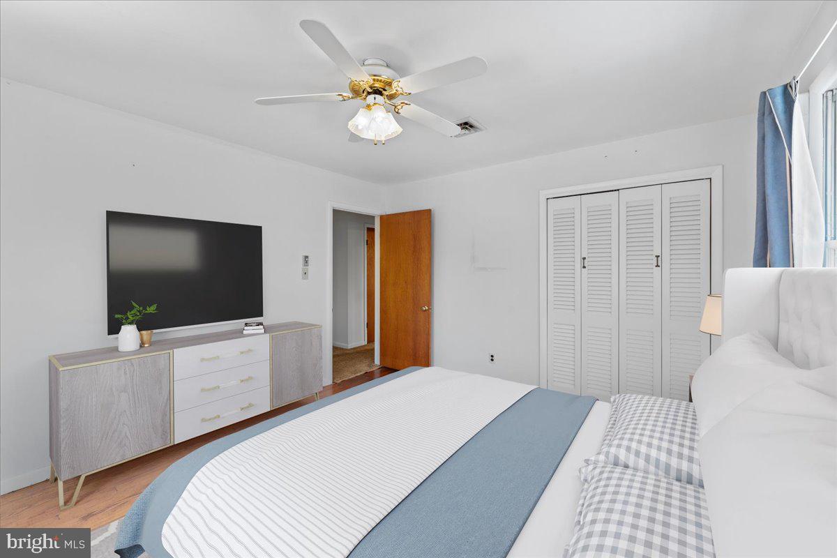 4801 Avery Road Shady Side, MD 20764 - Photo 20 of 25 a bedroom with a bed and a flat screen tv