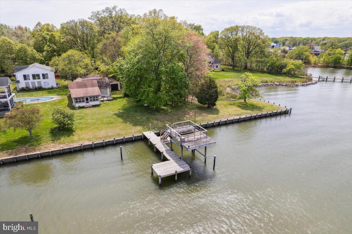 4801 Avery Road Shady Side, MD 20764 - Photo 2 of 25 an aerial view of a house with swimming pool and lake view