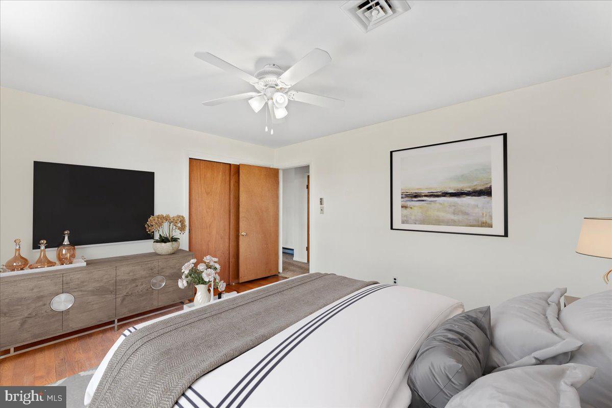 4801 Avery Road Shady Side, MD 20764 - Photo 22 of 25 a bedroom with a bed and a flat screen tv