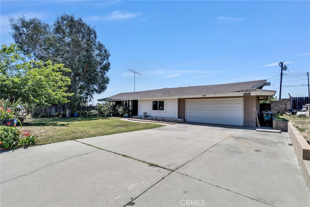 6254 Stanton Avenue Highland, CA 92346 - Photo 1 of 29 a front view of a house with yard and a garage