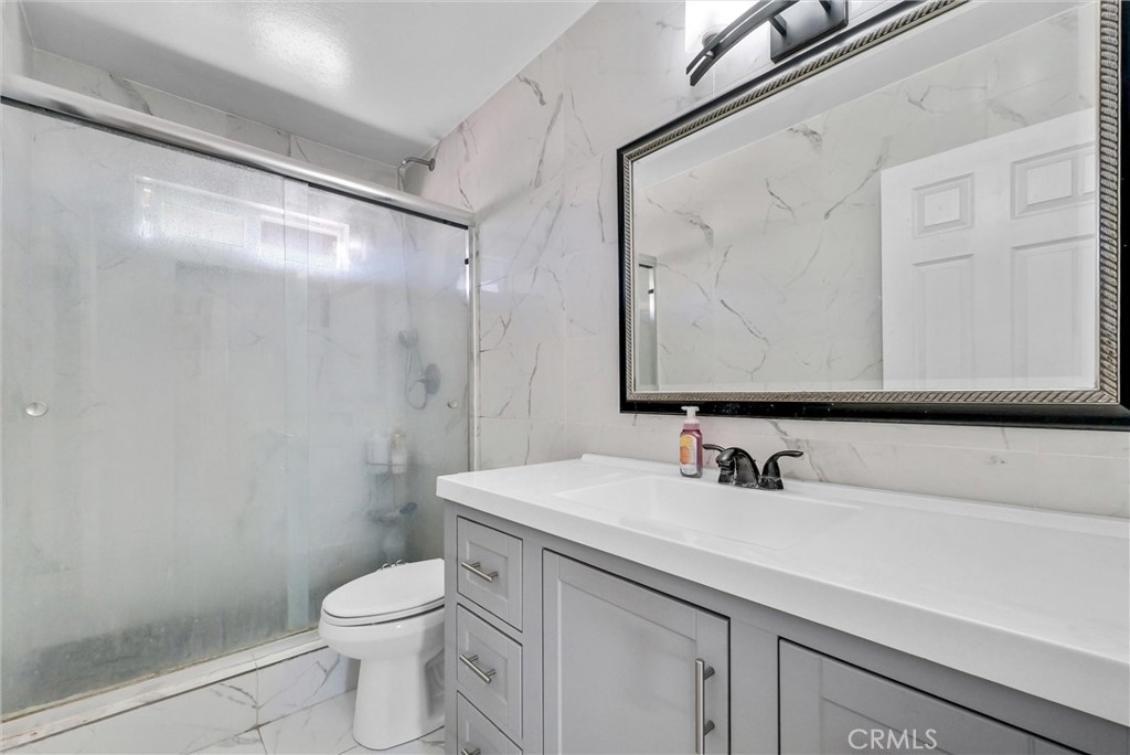 6254 Stanton Avenue Highland, CA 92346 - Photo 20 of 29 a bathroom with a sink a toilet and a mirror