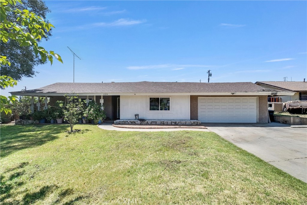 6254 Stanton Avenue Highland, CA 92346 - Photo 2 of 29 a front view of a house with a yard and garage
