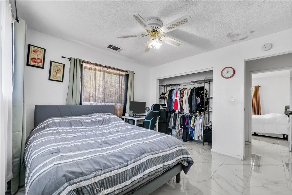 6254 Stanton Avenue Highland, CA 92346 - Photo 26 of 29 a bed room with a bed and a mirror