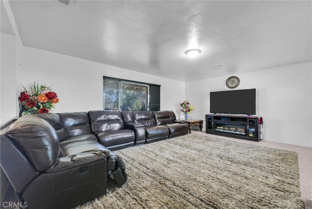 6254 Stanton Avenue Highland, CA 92346 - Photo 5 of 29 a living room with furniture and a flat screen tv