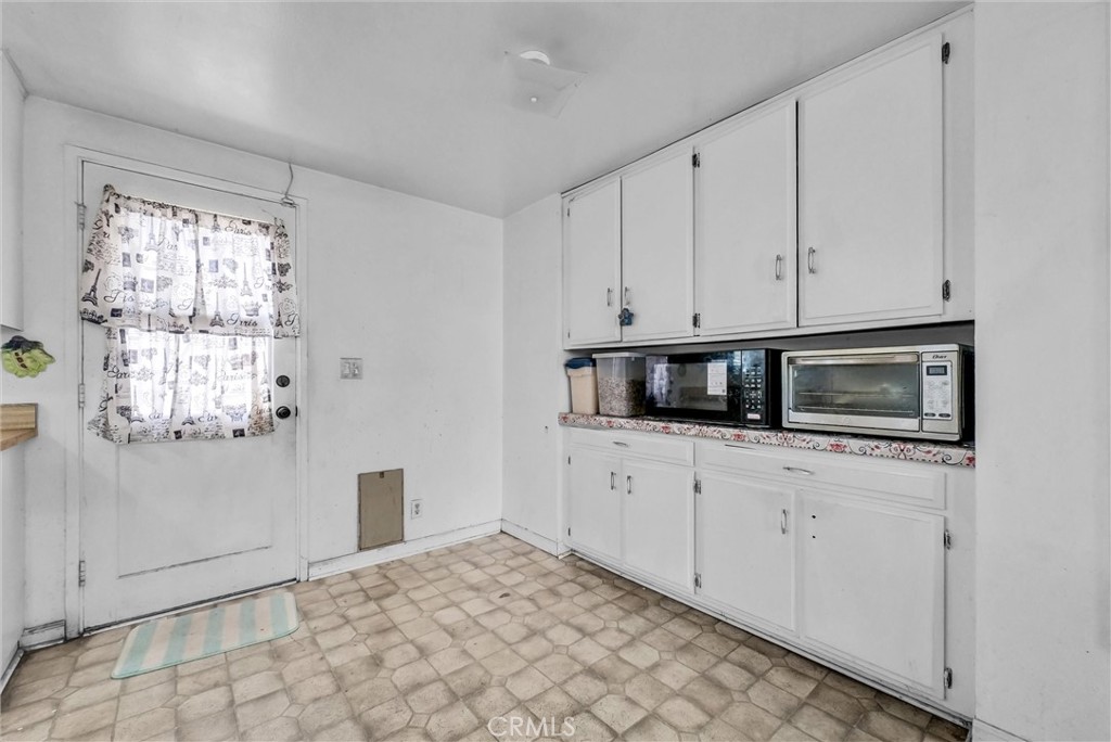 6254 Stanton Avenue Highland, CA 92346 - Photo 10 of 29 a kitchen with granite countertop white cabinets and stainless steel appliances