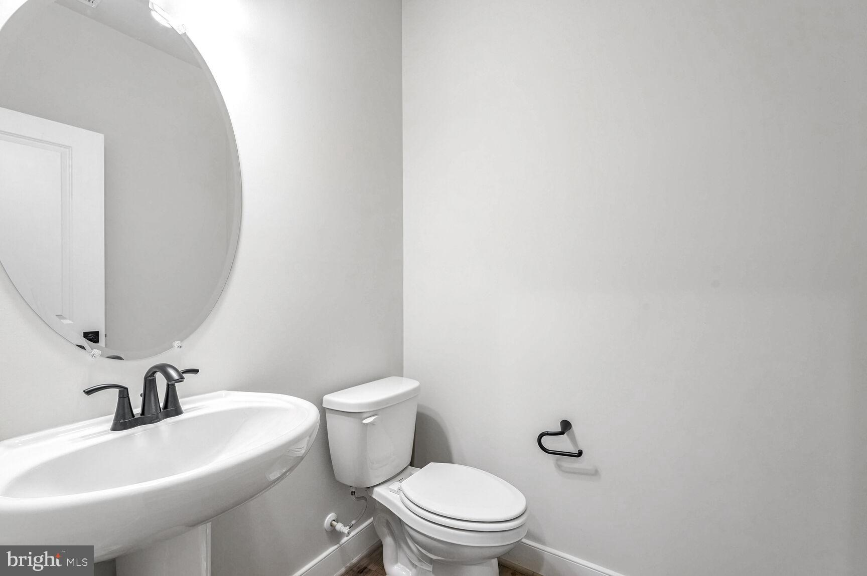 1769 Riverbluff Avenue Dumfries, VA 22026 - Photo 14 of 31 a white toilet sitting next to a bathroom sink