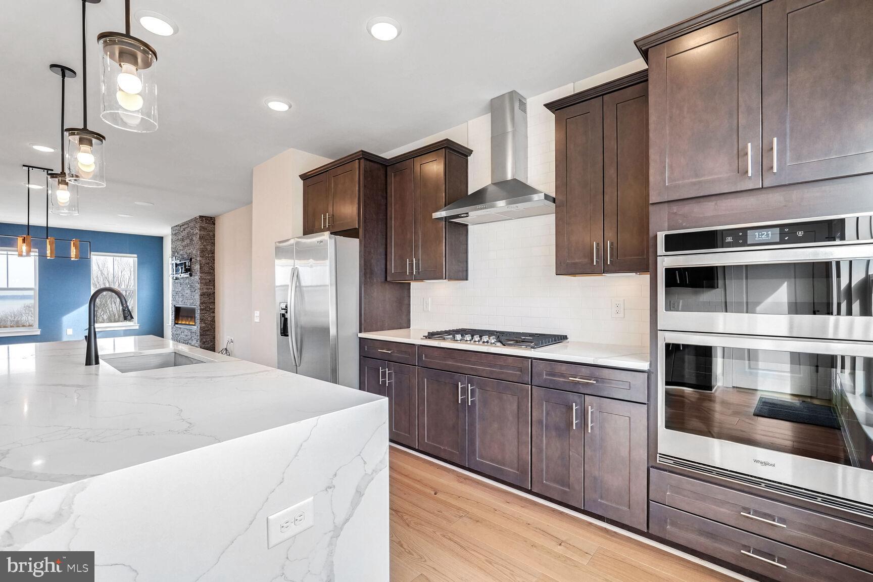 1769 Riverbluff Avenue Dumfries, VA 22026 - Photo 5 of 31 a kitchen with stainless steel appliances kitchen island granite countertop a refrigerator and a stove top oven