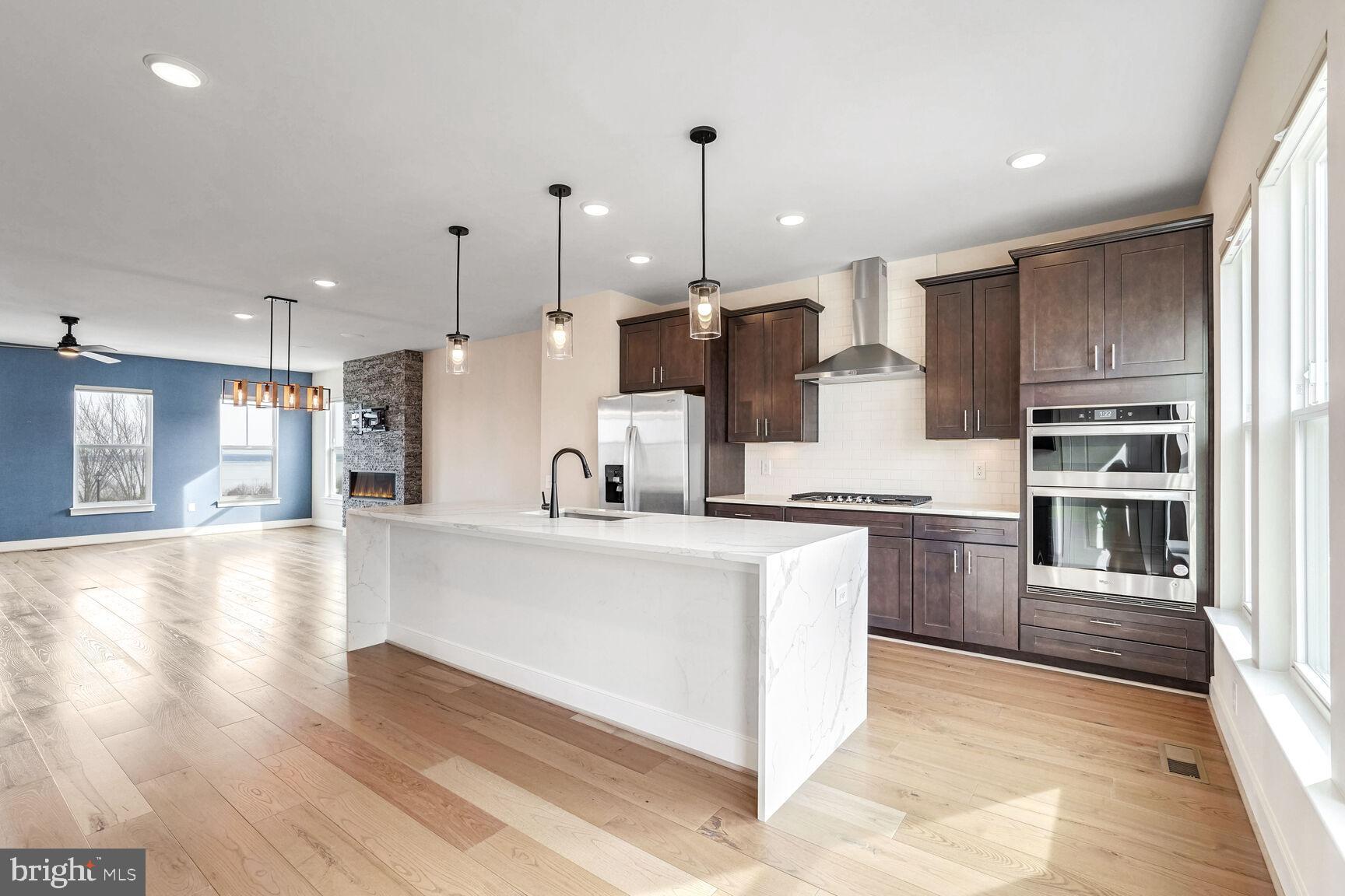 1769 Riverbluff Avenue Dumfries, VA 22026 - Photo 6 of 31 a large kitchen with stainless steel appliances kitchen island granite countertop a refrigerator a stove a sink and a oven