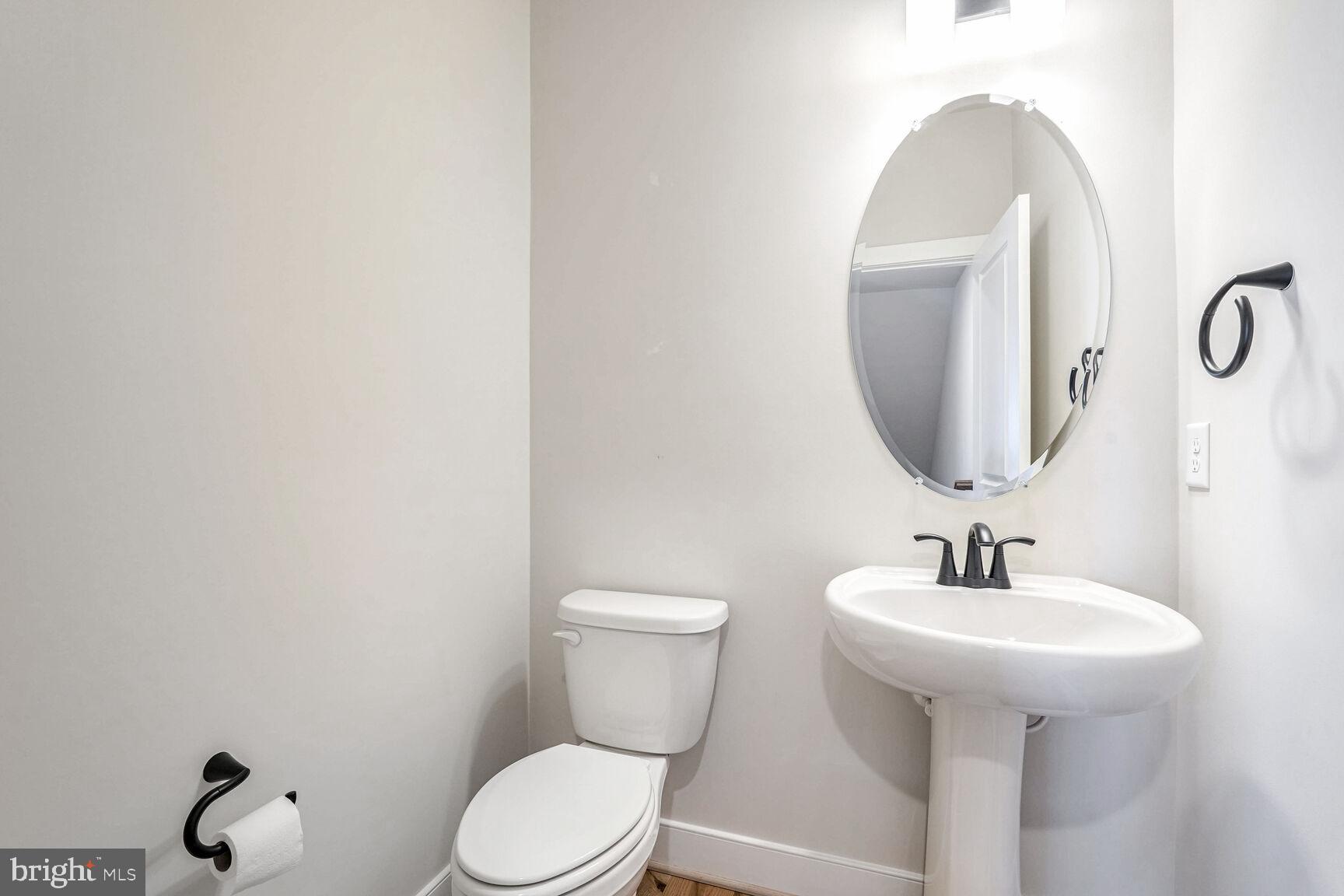 1769 Riverbluff Avenue Dumfries, VA 22026 - Photo 10 of 31 a bathroom with a toilet sink and mirror