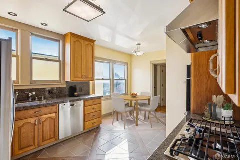 a kitchen with a sink and a refrigerator