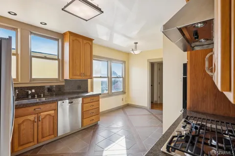 a view of a livingroom with wooden floor and a fireplace
