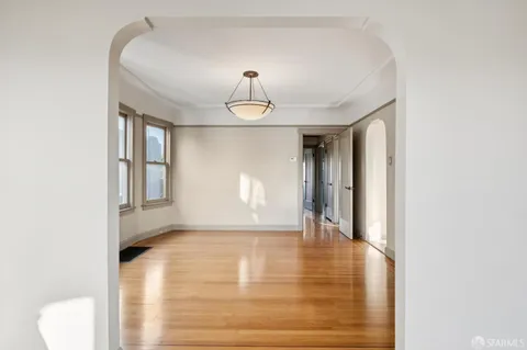 a large white kitchen with a sink and cabinets