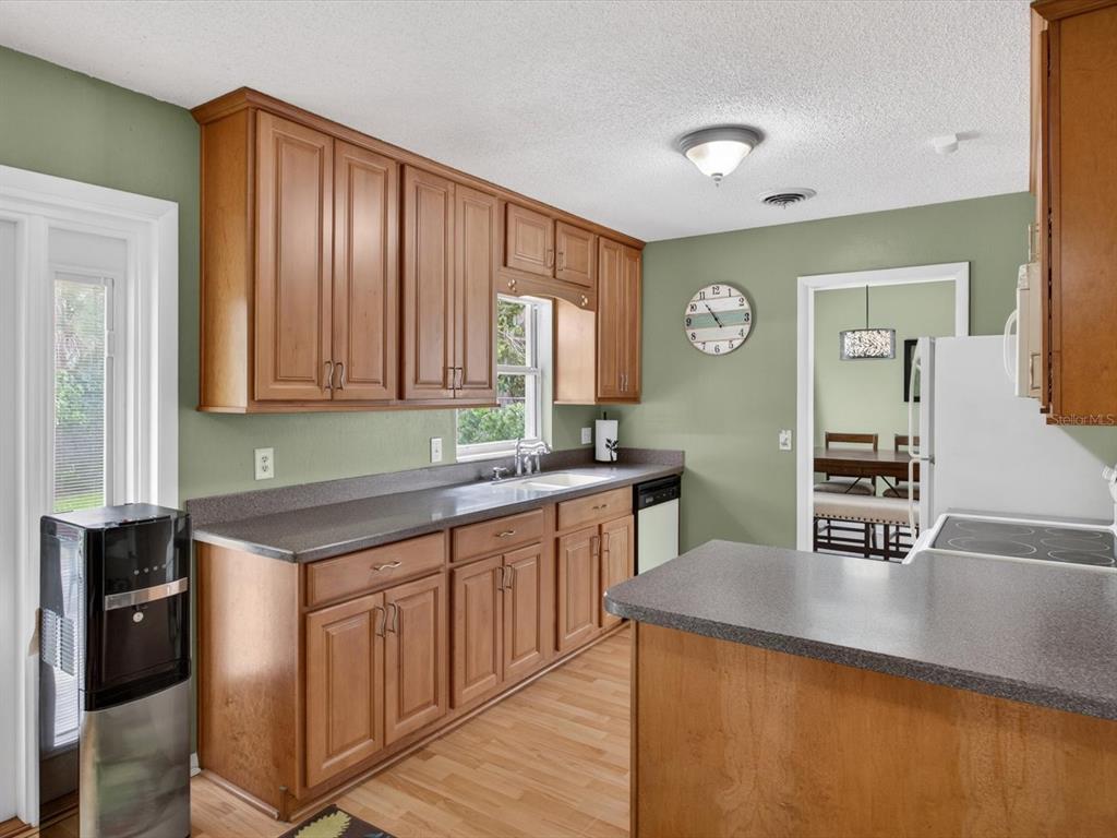 2803 Banchory Road Winter Park, FL 32792 - Photo 7 of 31 a kitchen with stainless steel appliances granite countertop a sink a stove counter space and cabinets