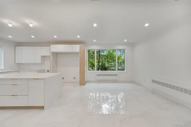a large kitchen with stainless steel appliances a large window