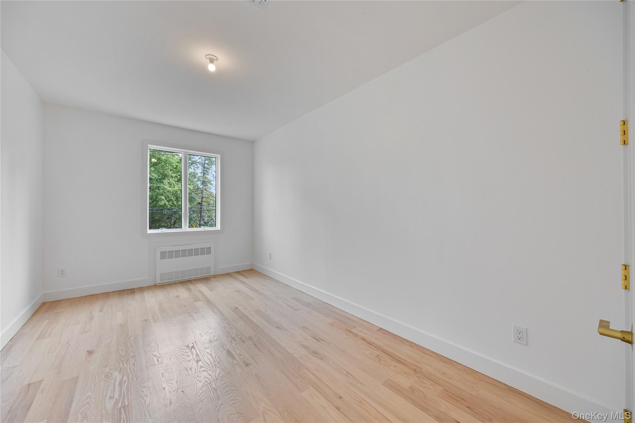 15 Northbrook Road, Unit 201 Spring Valley, NY 10977 - Photo 16 of 50 an empty room with wooden floor and windows