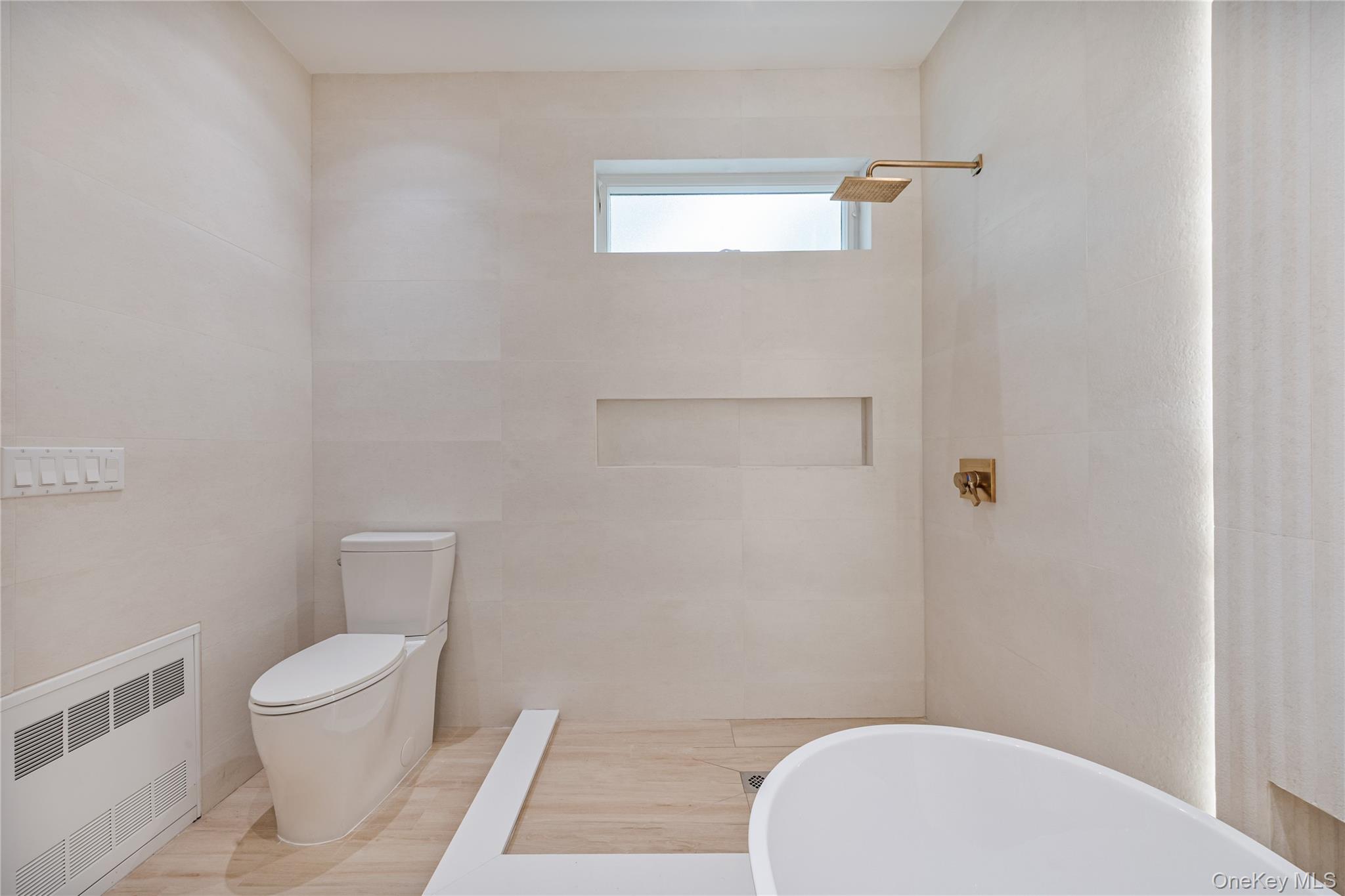 15 Northbrook Road, Unit 201 Spring Valley, NY 10977 - Photo 22 of 50 a white toilet sitting next to a bathroom sink