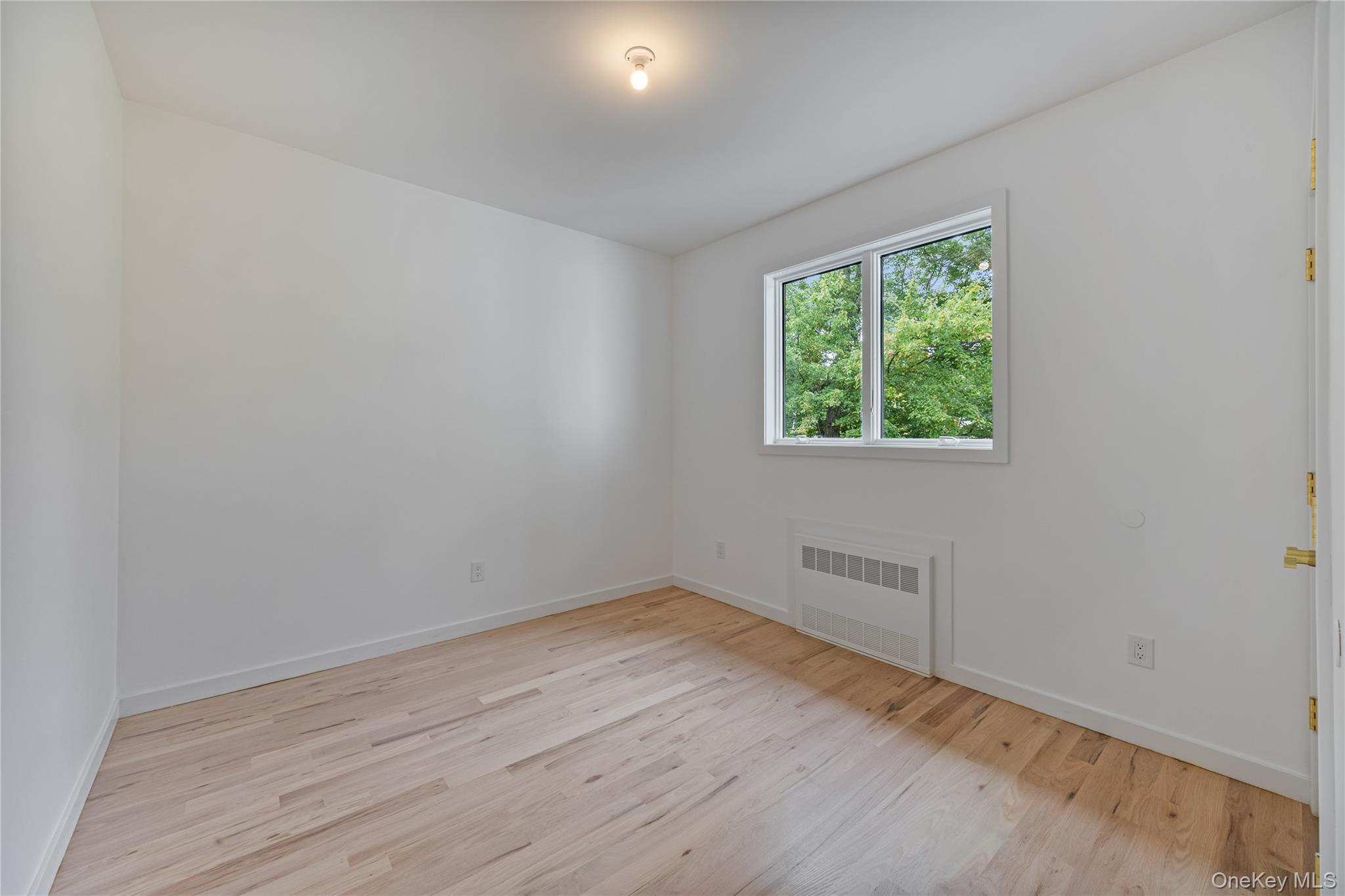 15 Northbrook Road, Unit 201 Spring Valley, NY 10977 - Photo 24 of 50 an empty room with wooden floor and windows