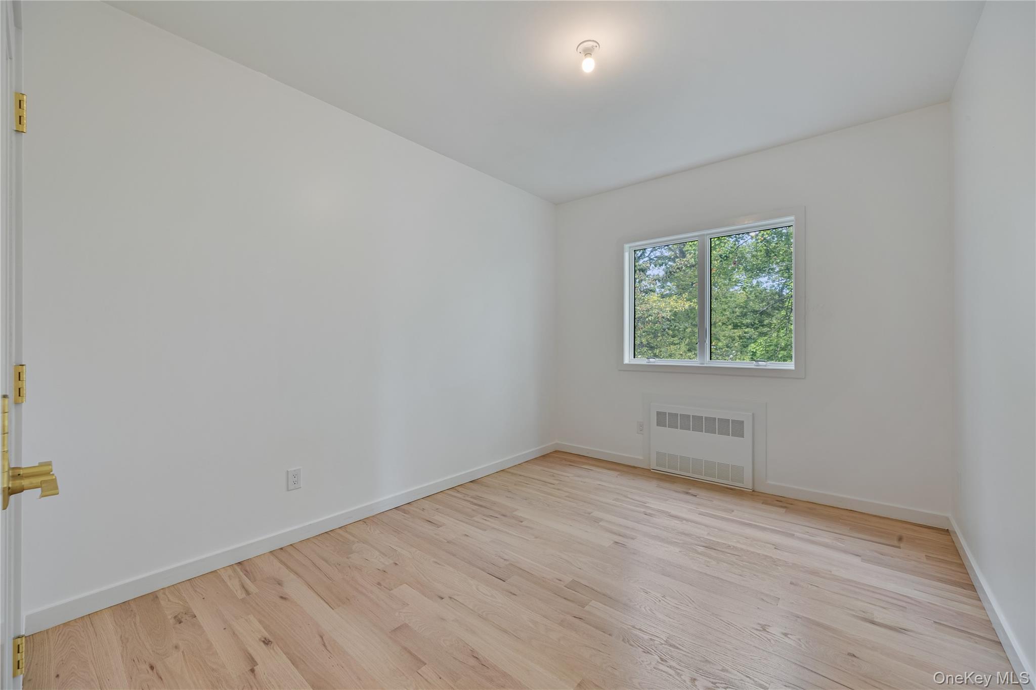 15 Northbrook Road, Unit 201 Spring Valley, NY 10977 - Photo 27 of 50 an empty room with wooden floor and windows