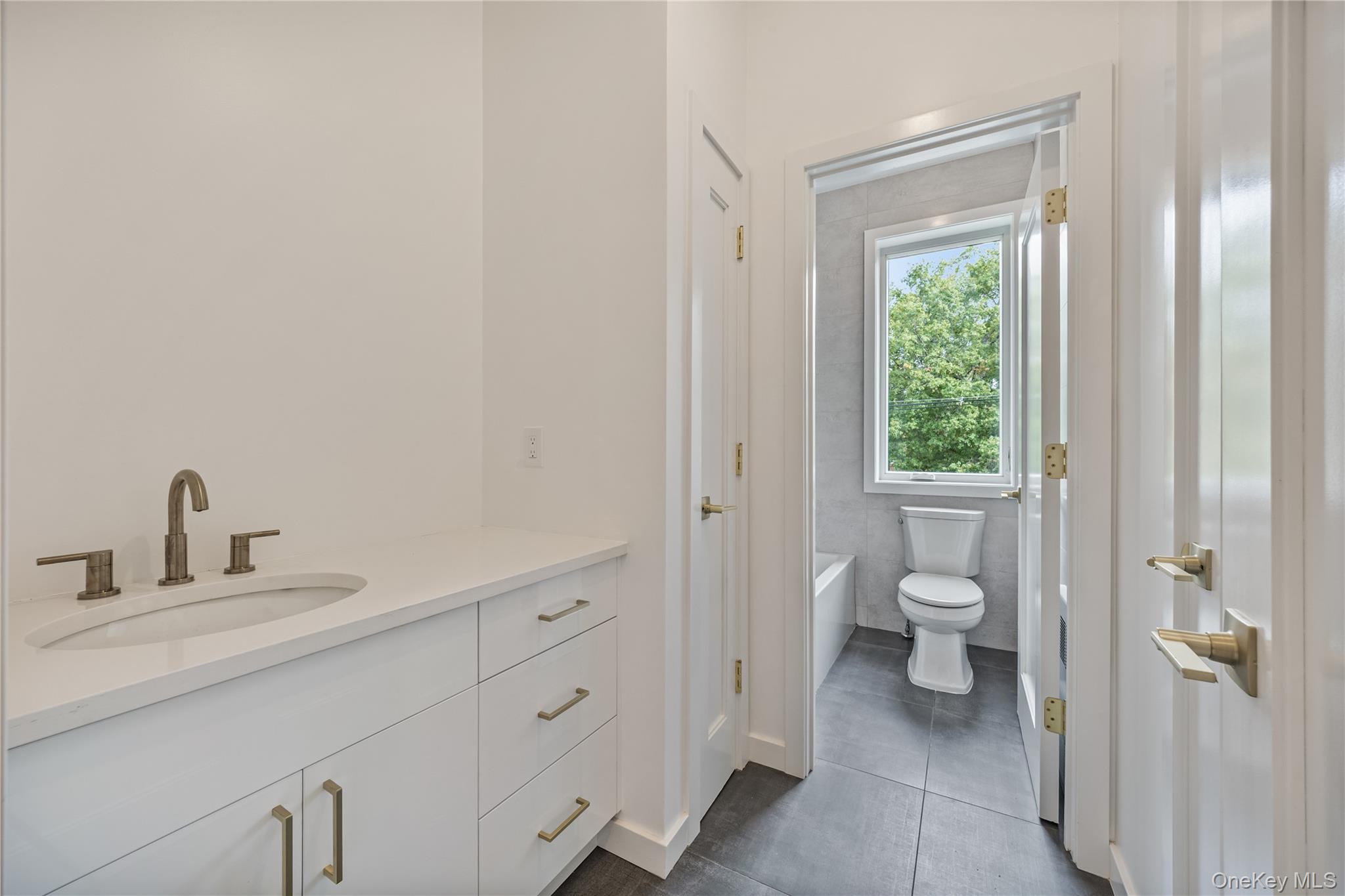 15 Northbrook Road, Unit 201 Spring Valley, NY 10977 - Photo 29 of 50 a bathroom with a toilet sink and a mirror