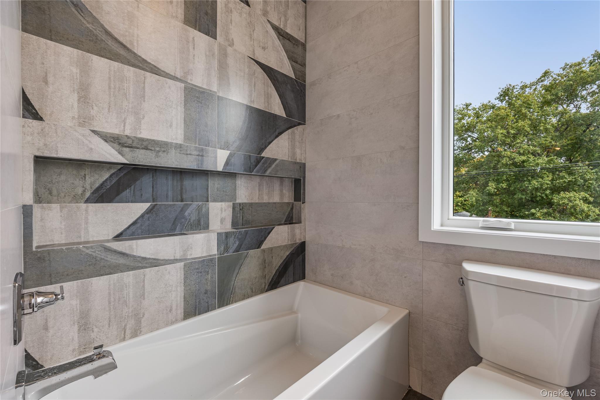 15 Northbrook Road, Unit 201 Spring Valley, NY 10977 - Photo 30 of 50 a bathroom with a toilet and a bathtub