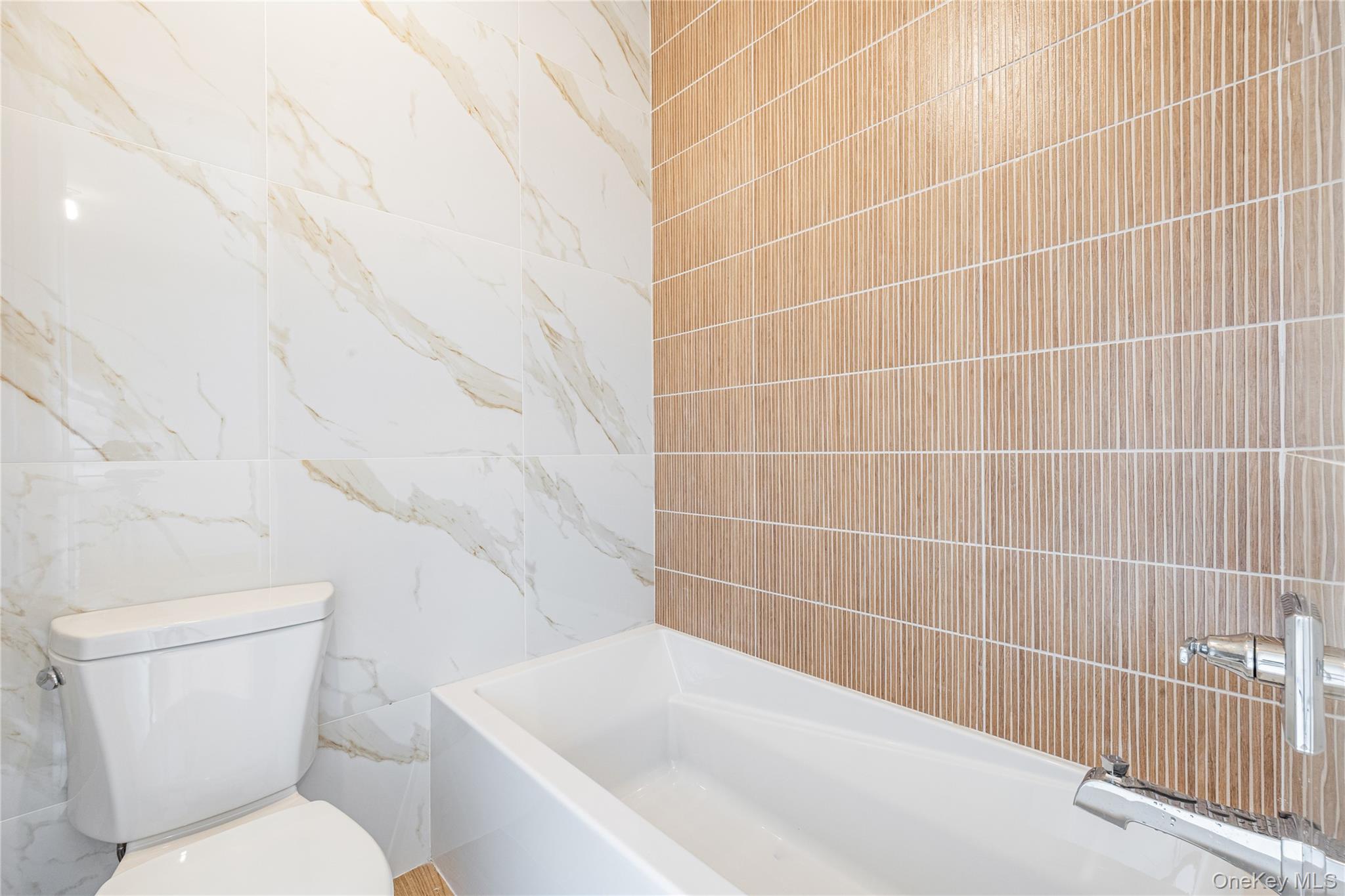 15 Northbrook Road, Unit 201 Spring Valley, NY 10977 - Photo 35 of 50 a white toilet sitting next to a white tub