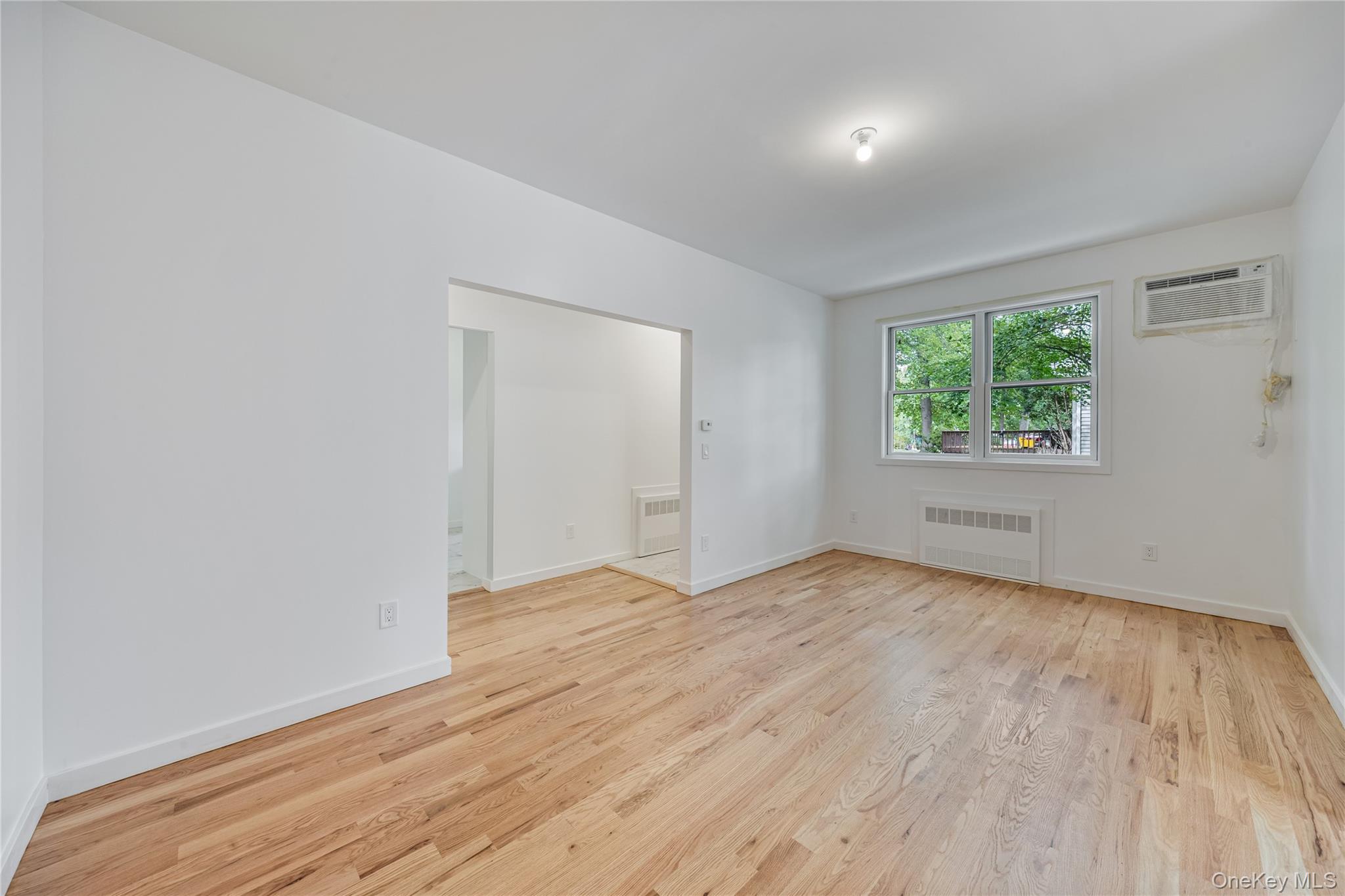 15 Northbrook Road, Unit 201 Spring Valley, NY 10977 - Photo 37 of 50 a view of an empty room with wooden floor and a window