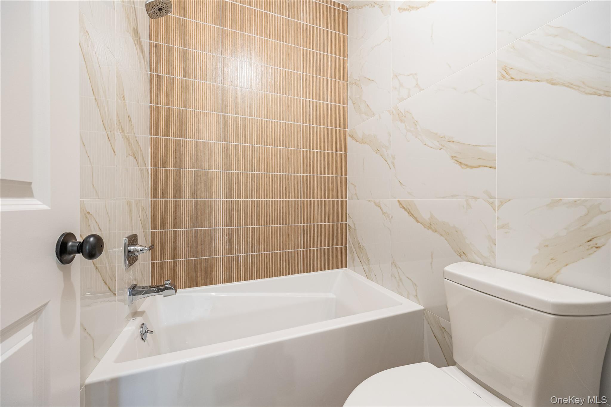 15 Northbrook Road, Unit 201 Spring Valley, NY 10977 - Photo 41 of 50 a white bath tub sitting next to a white toilet and sink