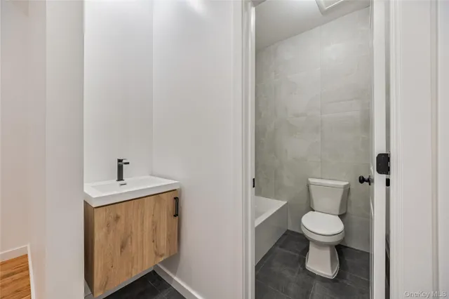 a white toilet sitting next to a bathroom sink