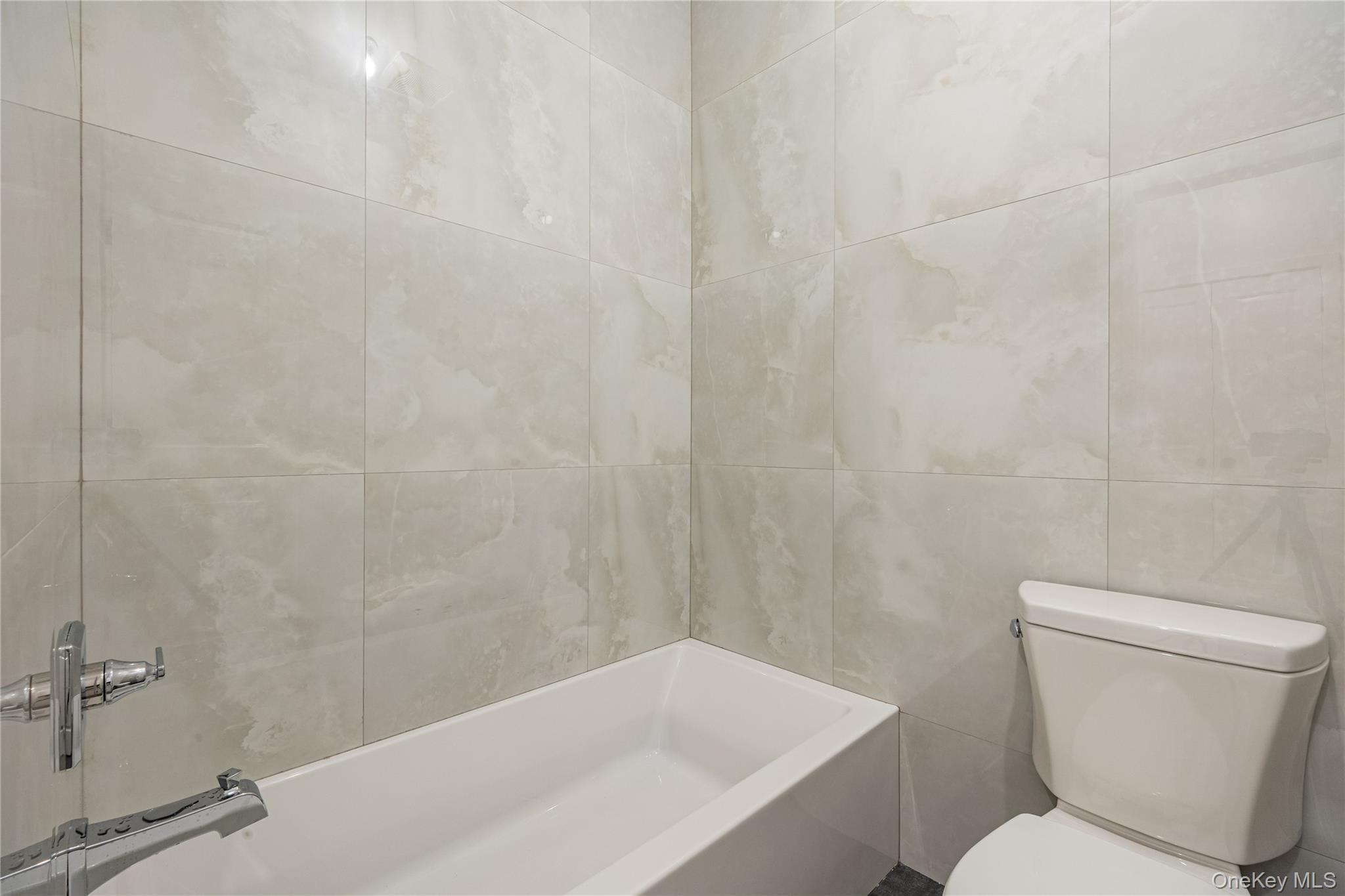 15 Northbrook Road, Unit 201 Spring Valley, NY 10977 - Photo 45 of 50 a white toilet sitting next to a bath tub