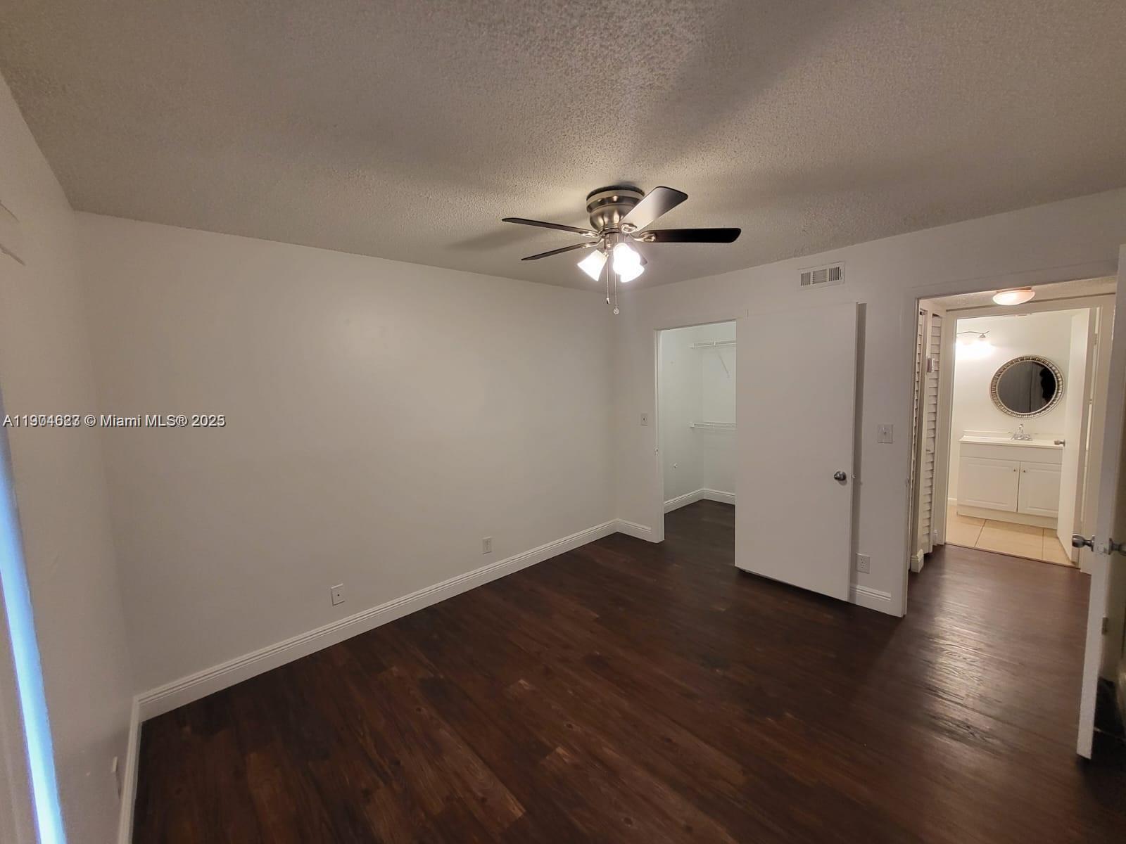 5654 Rock Island Road, Unit 222 Tamarac, FL 33319 - Photo 13 of 21 an empty room with wooden floor and windows