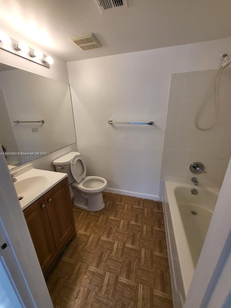 5654 Rock Island Road, Unit 222 Tamarac, FL 33319 - Photo 17 of 21 a bathroom with a sink a toilet and shower