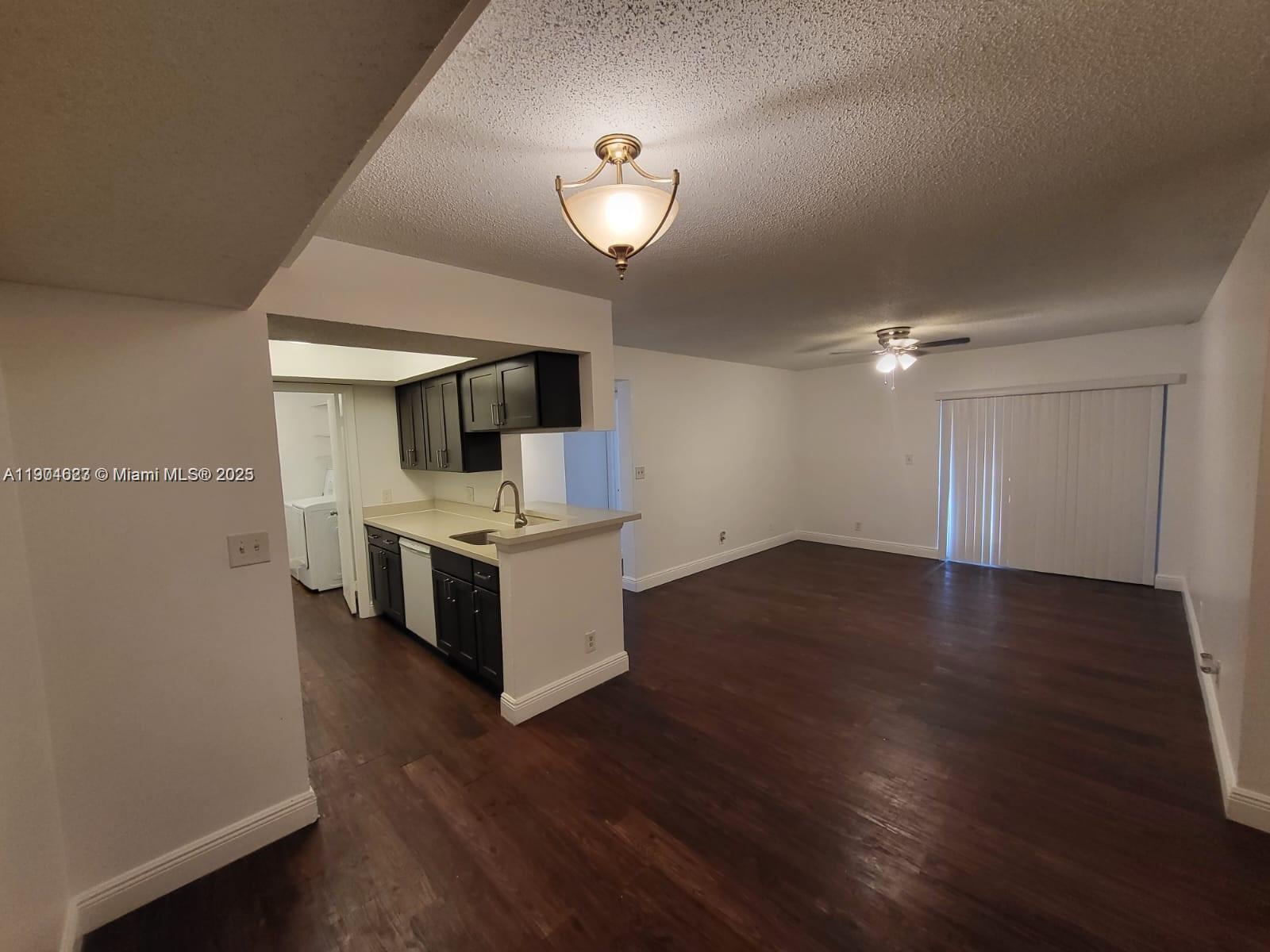 5654 Rock Island Road, Unit 222 Tamarac, FL 33319 - Photo 3 of 21 a view of a kitchen with a sink and a stove top oven