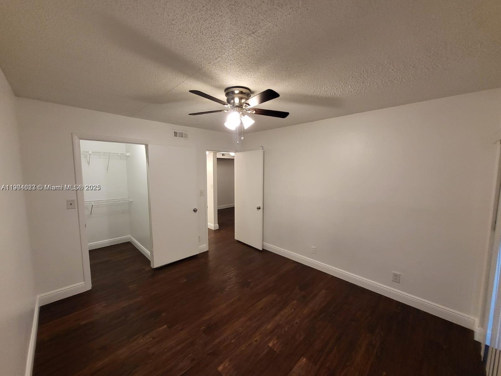 5654 Rock Island Road, Unit 222 Tamarac, FL 33319 - Photo 9 of 21 a view of an empty room with wooden floor
