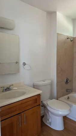 a bathroom with a toilet a sink and bathtub