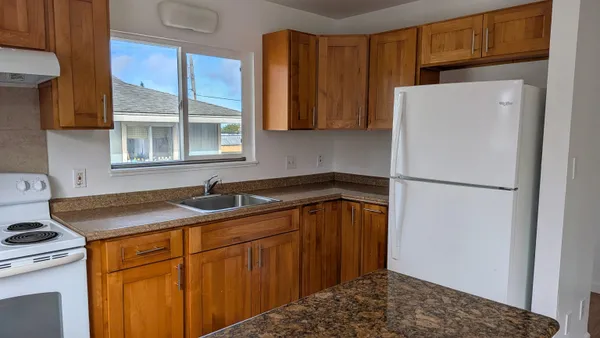 a kitchen with a refrigerator and a sink