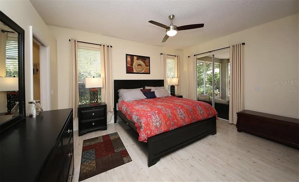 5324 Cottonwood Tree Circle Valrico, FL 33596 - Photo 11 of 27 a bedroom with a bed and a flat screen tv