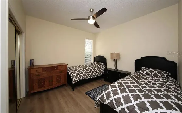 a bedroom with two beds and a chandelier