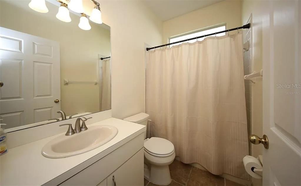 5324 Cottonwood Tree Circle Valrico, FL 33596 - Photo 17 of 27 a bathroom with a sink a toilet and shower curtain