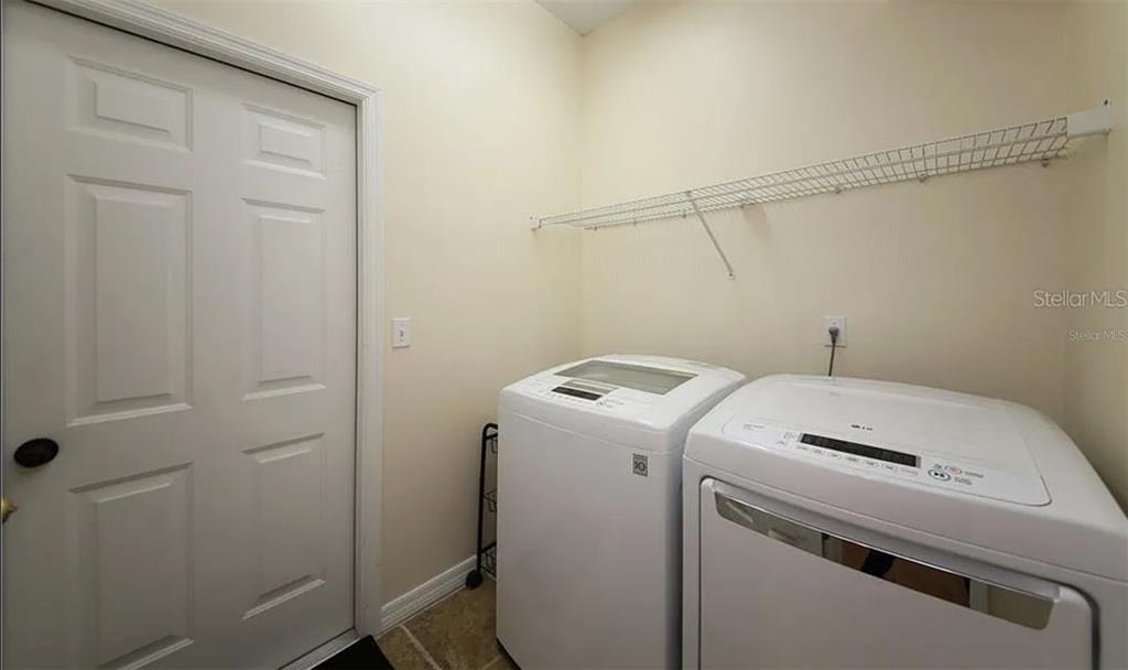 5324 Cottonwood Tree Circle Valrico, FL 33596 - Photo 18 of 27 a utility room with dryer and washer