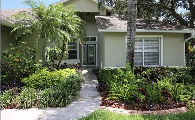 a front view of a house with plants