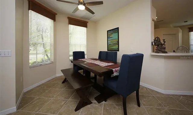 a view of a dining room with furniture and window